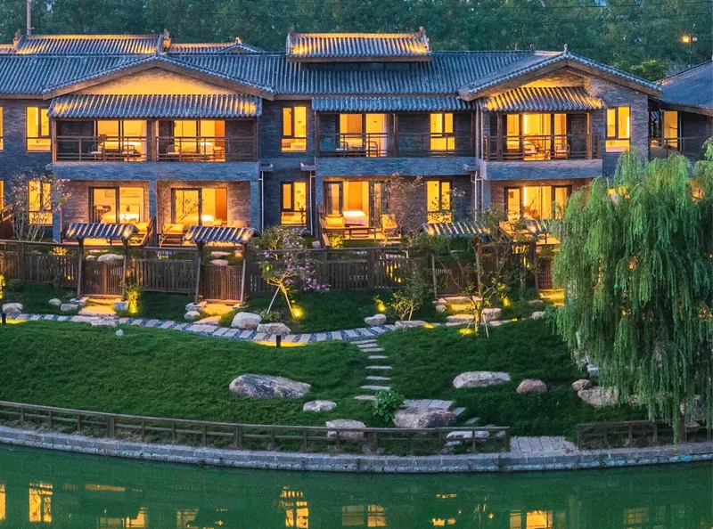 Waterfront buildings and evening lights at Bagongju Wumingchu in Shouxian